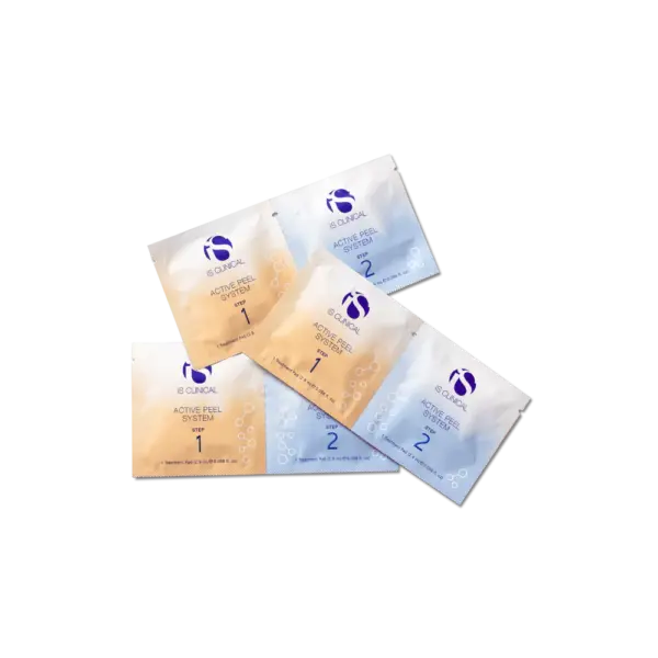 Five small sachets from the Is Clinical Active Peel System (pack of 15)—three beige Step 1 and two light blue Step 2—are arranged on a black surface, showcasing a selection from the skincare set.