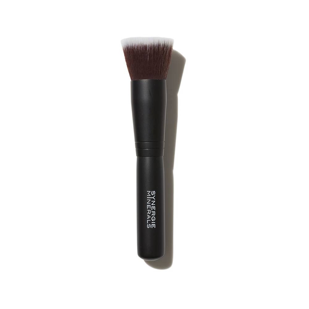 A black, synthetic fiber makeup brush with the label "minerals" printed in white on its handle, photographed on a solid white background.