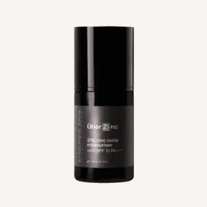 A black container of synergie skin überzinc moisturizer with spf 15, labeled prominently in white text. the packaging is sleek and modern, isolated on a white background.