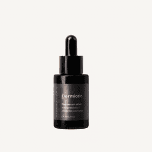 A black glass bottle with a dropper, labeled "dermiotic pre-serum elixir with prebiotic and probiotic complex," against a white background.