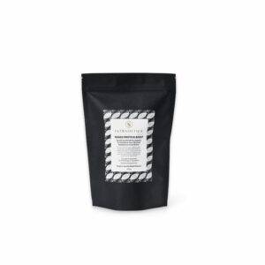 Black stand-up pouch with a white label showcasing product information for "Intrametica Toned Protein Boost." The label has a geometric pattern on the top and bottom.