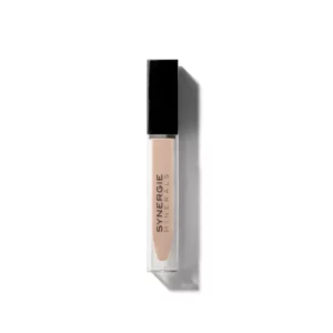 A clear tube of LiquiDew concealer with a black cap is shown from above on a white background, revealing the beige product inside.